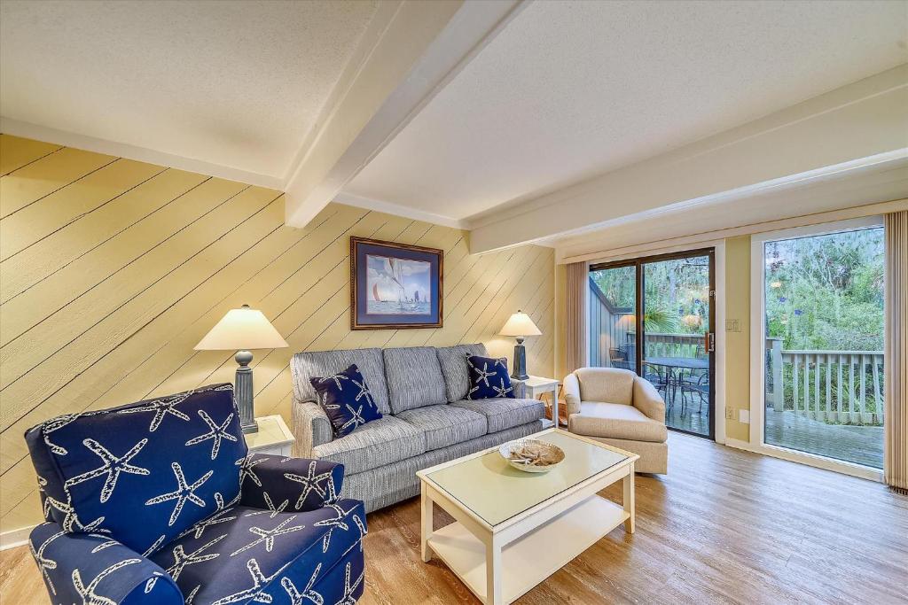 a living room with a couch and a table at Beachwalk 110 in Hilton Head Island