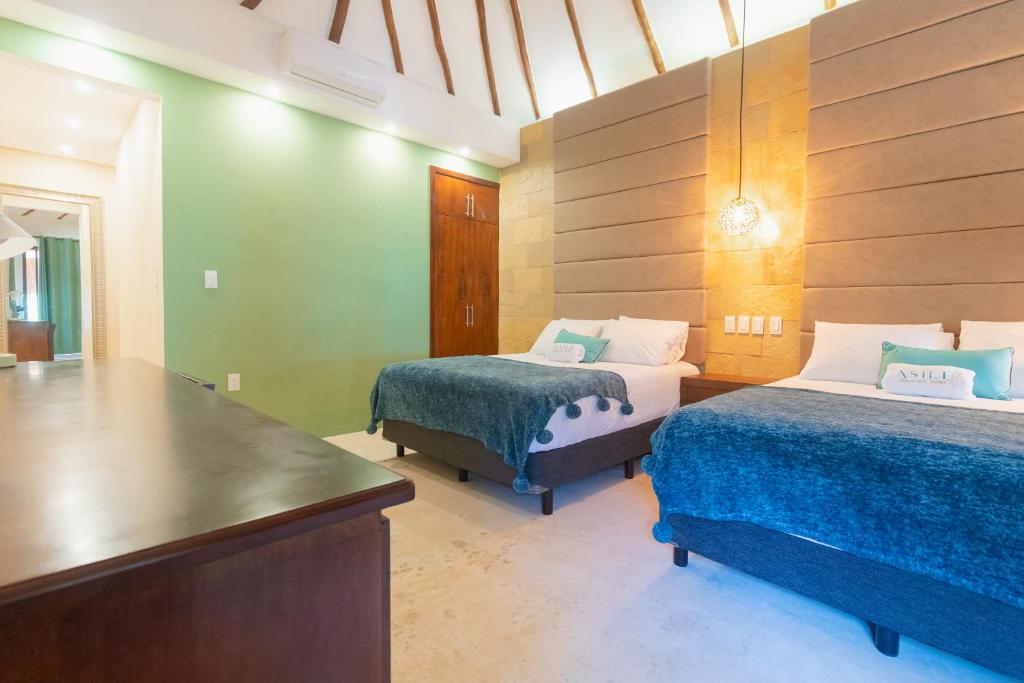 Postel nebo postele na pokoji v ubytování Mayan Playa Bacalar