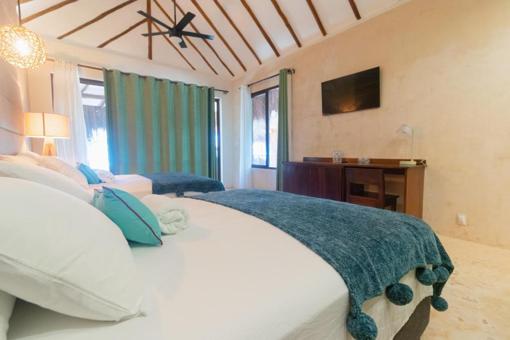 Postel nebo postele na pokoji v ubytování Mayan Playa Bacalar