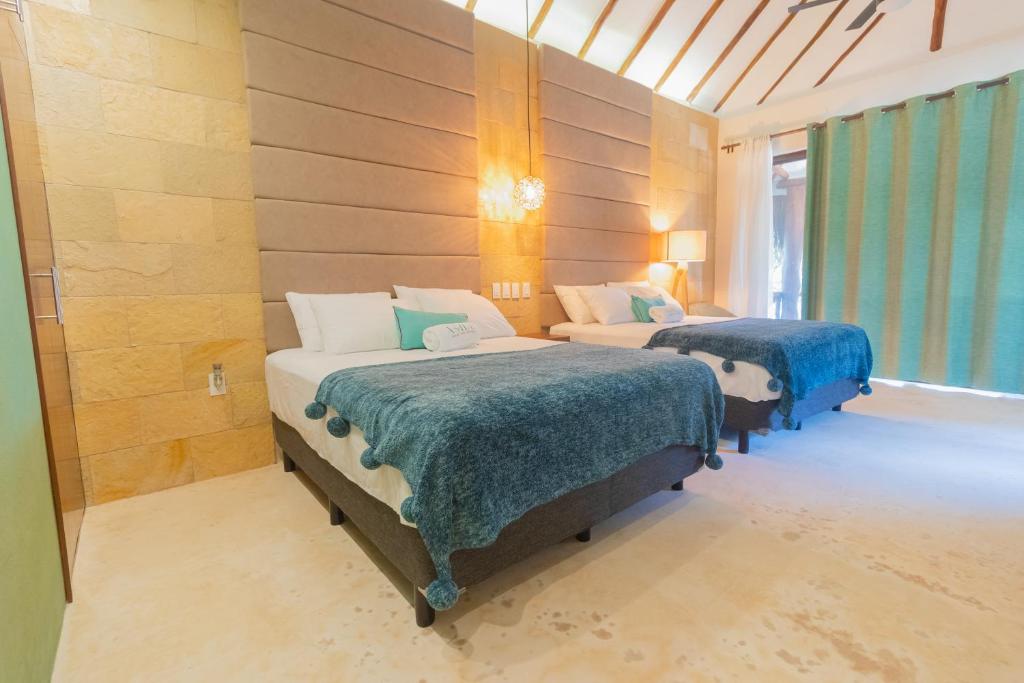 Postel nebo postele na pokoji v ubytování Mayan Playa Bacalar