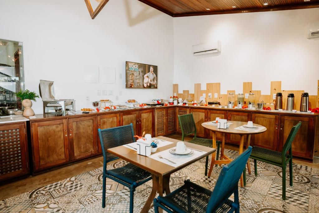 a restaurant with two tables and chairs in a room at Pousada Luar da Ilha in Fernando de Noronha