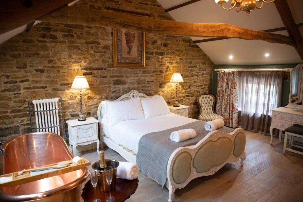 Кровать или кровати в номере The Footmans Cottage