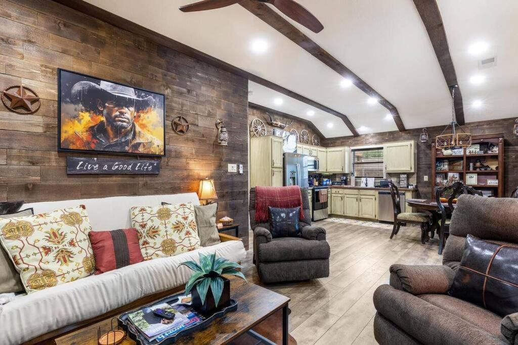a living room with a couch and chairs and a kitchen at Stockyards 5 mins!-New!-Sleeps 8. Cowboy Bungalow in Fort Worth