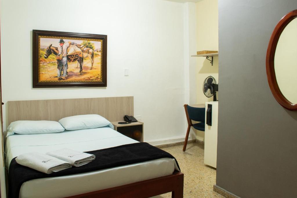 Postel nebo postele na pokoji v ubytování Hotel Caldas Plaza