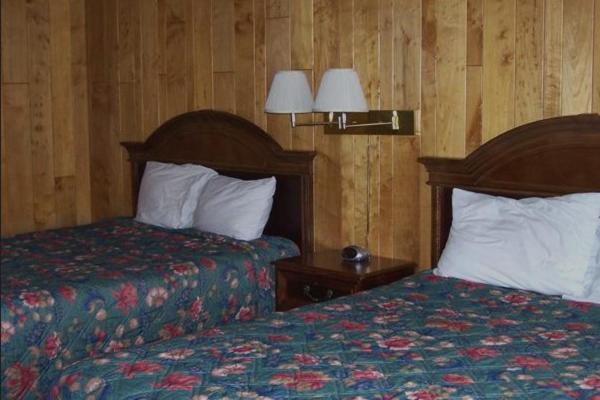 a hotel room with two beds in a room at Delta Motel in Bay City