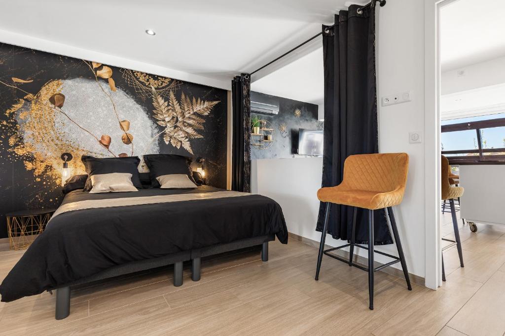 une chambre avec un grand lit et une chaise dans l'établissement VILLA GOLDEN PARADISE, au Cap d'Agde
