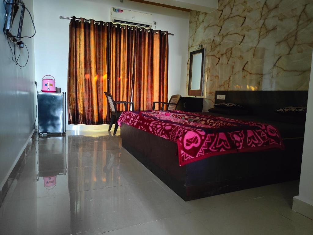 a bedroom with a bed with a pink blanket on it at Hiral valley view residency matheran in Matheran