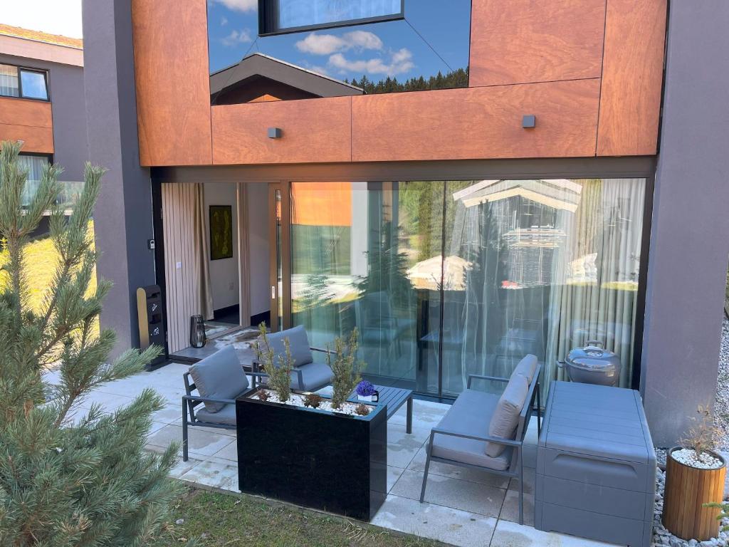 a house with two chairs and a table in a courtyard at apartmanhrabovob14 in Ružomberok