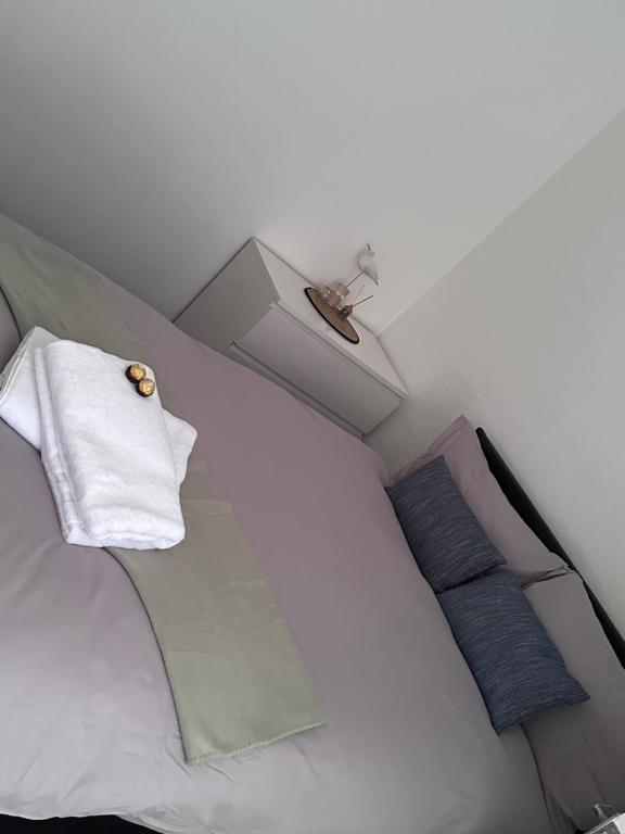 a white bed with two pillows on top of it at 3 bed house in Leicester! in Leicester