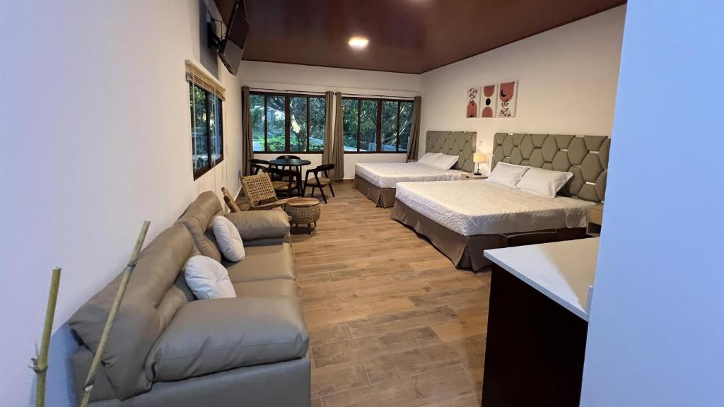 a living room with two beds and a couch at Aire de Montaña 3 - Hot Springs in Ahuachapán