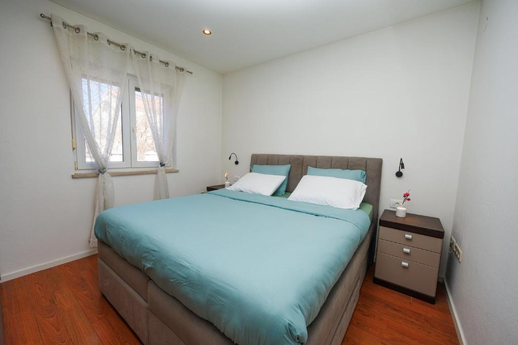 Łóżko lub łóżka w pokoju w obiekcie Apartment Nikoleto