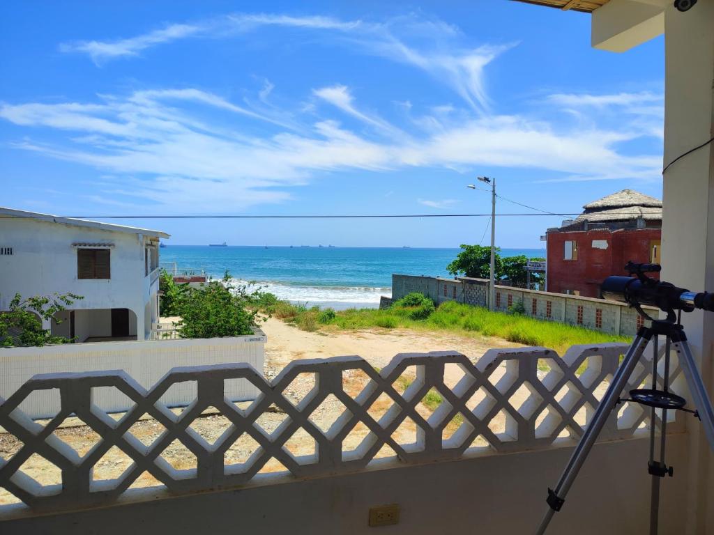 a camera on a balcony with a view of the beach at Casa de Hamacas in Ballenita