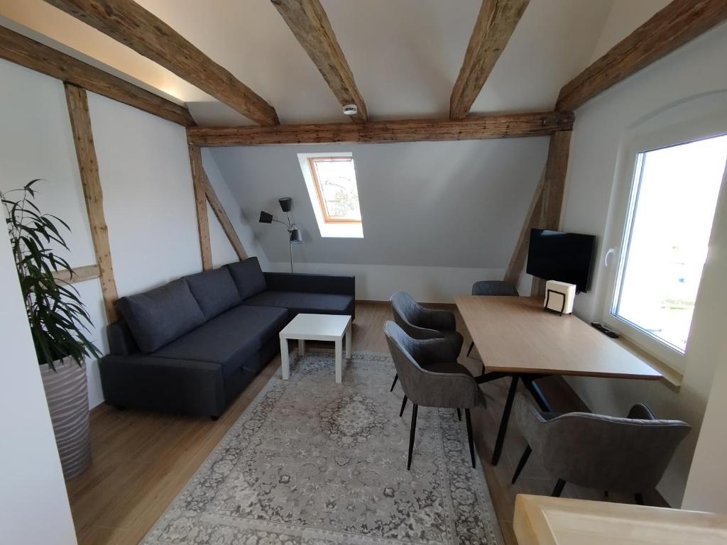 a living room with a couch and a table at Storchennest - Ferienwohnung am Storchenradweg in Ketzür