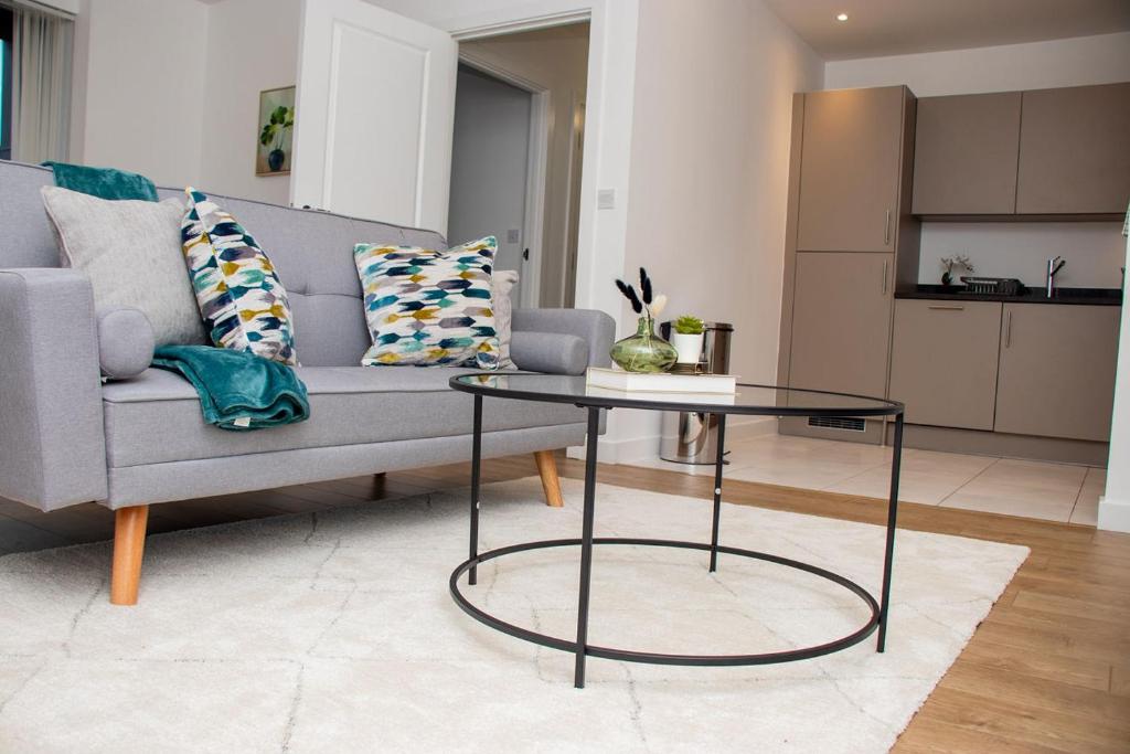 a living room with a couch and a glass table at Canary Haven- Luxury 2 bedroom 2 bathroom Apartment in London
