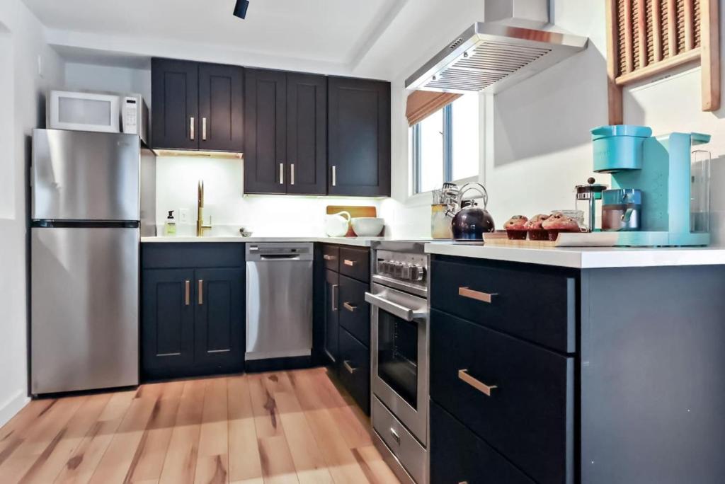 a kitchen with black cabinets and stainless steel appliances at Cozy Hideaway Retreat Unit 4 near Durango in Durango