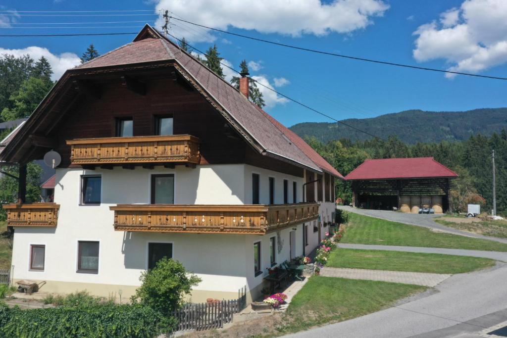 a large white building with a wooden roof at Apartment Komar in Sankt Stefan an der Gail