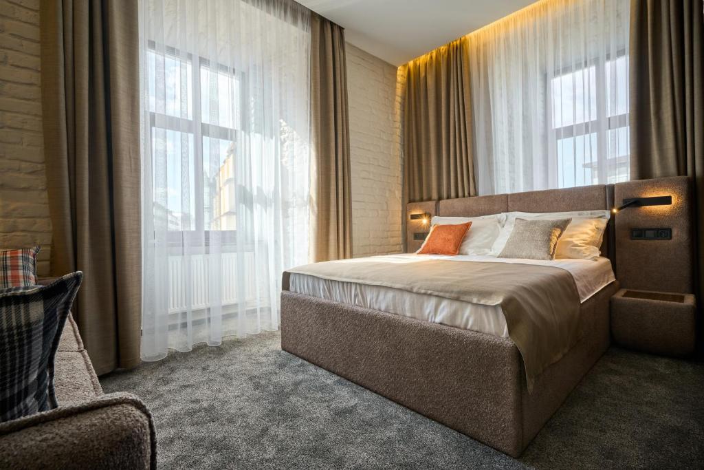 Postel nebo postele na pokoji v ubytování FIMKA Apart Hotel