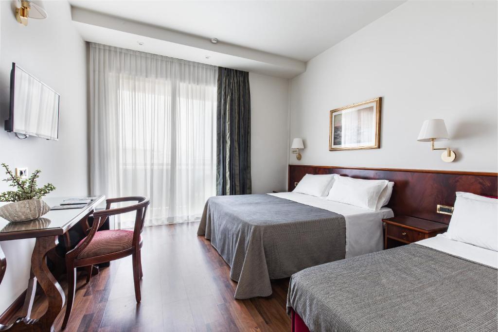 Postel nebo postele na pokoji v ubytování Hotel Ambasciatori