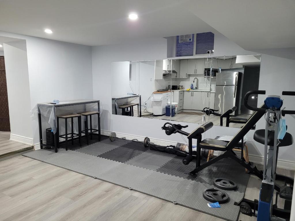 a room with a kitchen with a gym at Cozy Room in a Quiet Neighbourhood in Toronto