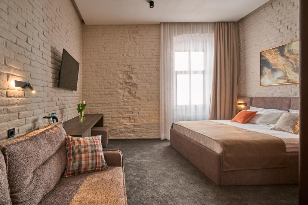 Postel nebo postele na pokoji v ubytování FIMKA Apart Hotel
