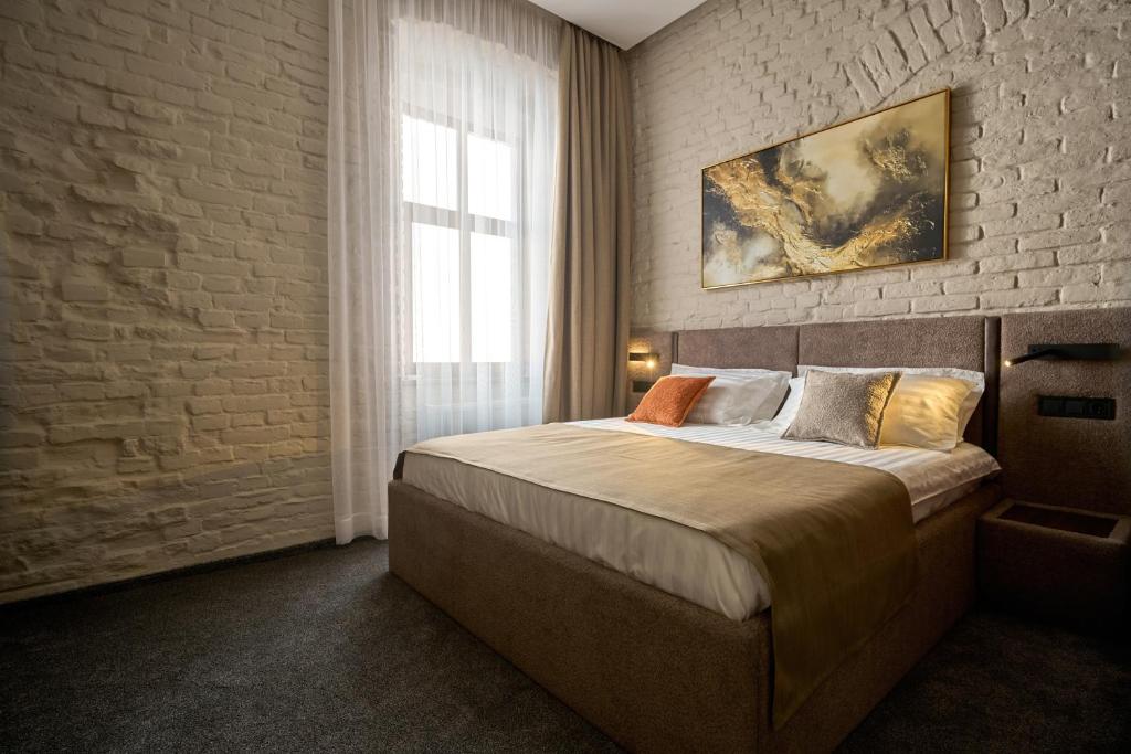 Postel nebo postele na pokoji v ubytování FIMKA Apart Hotel