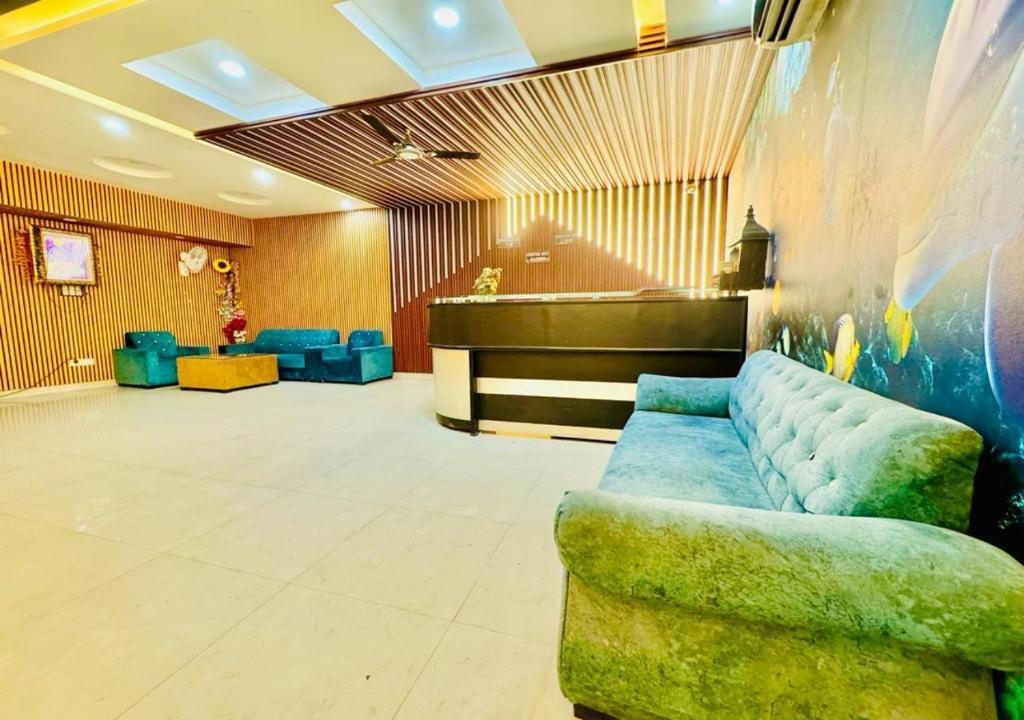 a lobby with a couch and a piano at Galaxyy The Hotel Near Delhi Airport in New Delhi