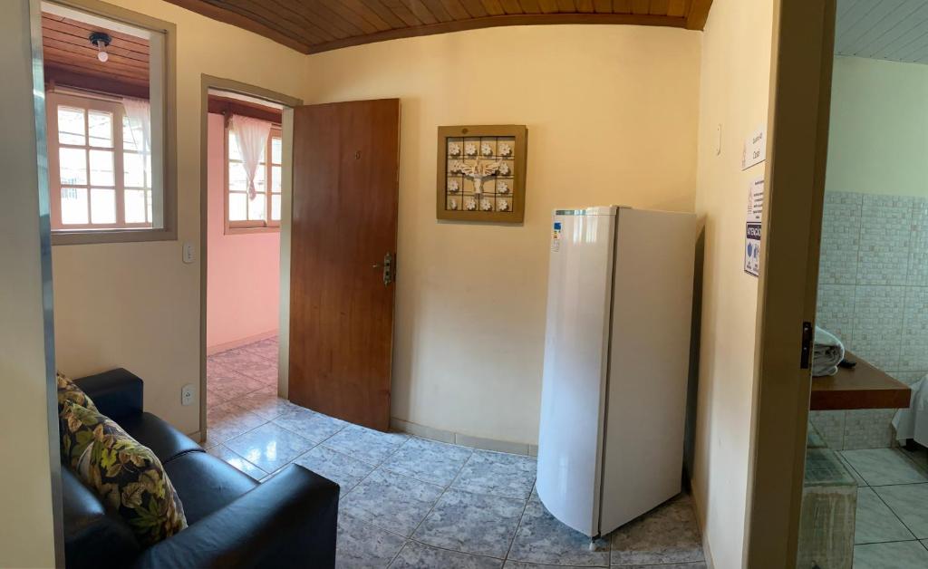 a kitchen with a refrigerator in a room at Hospedaria Vila Rica - Pousada a 1 km do Centro Histórico in Ouro Preto