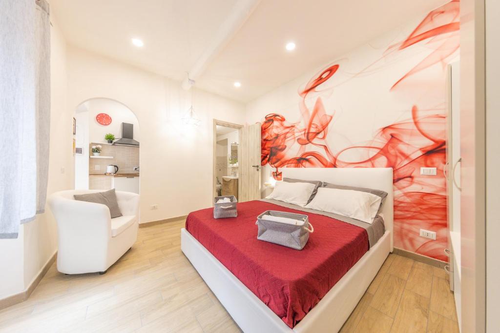a bedroom with a large bed with a red blanket at Aura 18 in Frascati