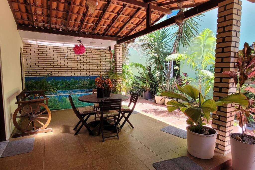 Nana's House Vilas في لورو دي فريتاس: فناء مع طاولة وكراسي والنباتات