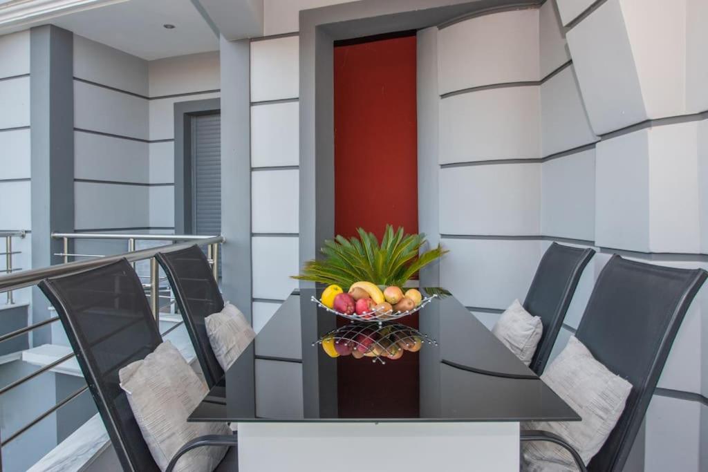 a table with a bowl of fruit on a balcony at La Vie Villa in Zakynthos