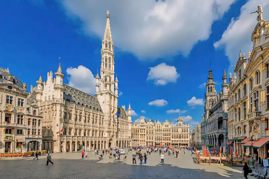 a city square with a large building with a clock tower at Centre ville Bruxelles/ Bruxelles City Center in Brussels