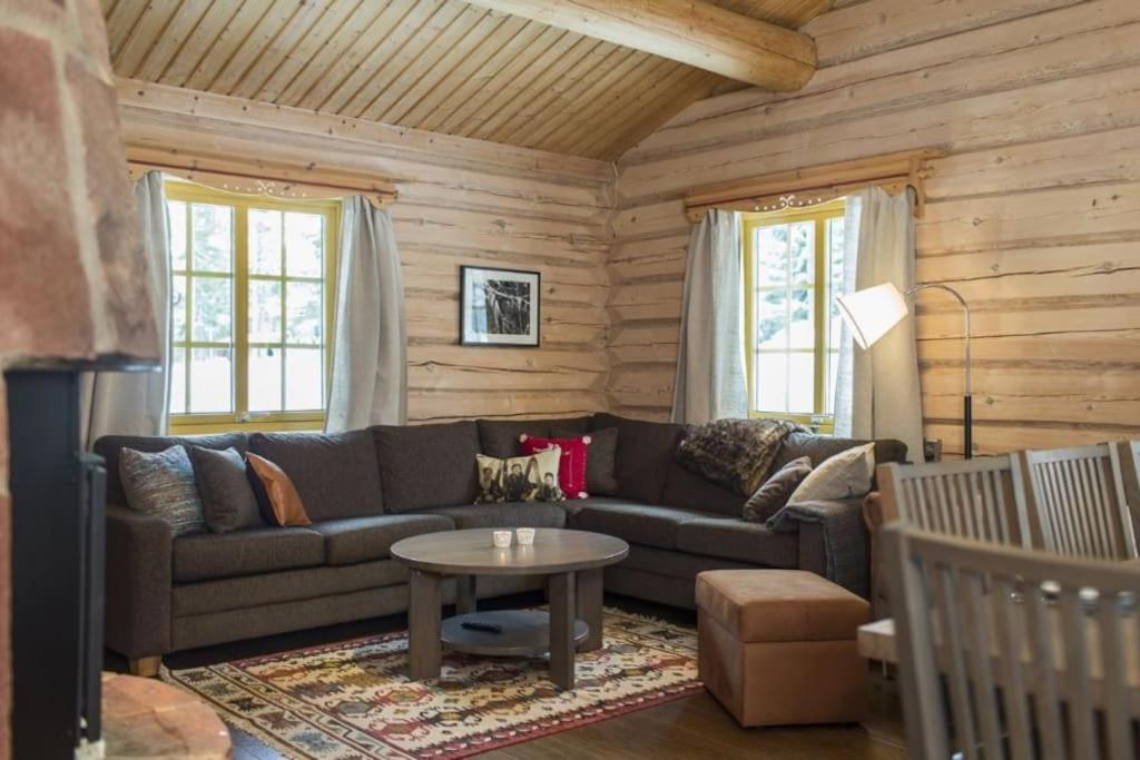 a living room with a couch and a table at Aktiv familjesemester i Lindvallen. MTB, downhill, vandring, sommarskidåkning & bad. 30:e juni till 6:e juli in Sälen
