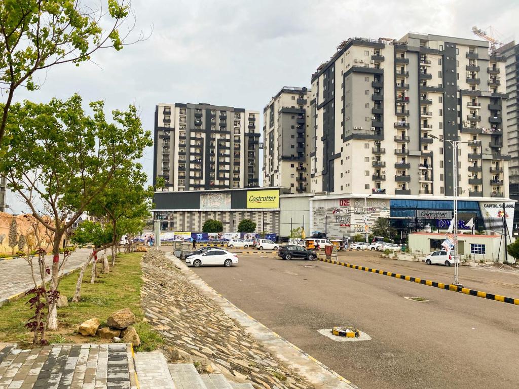 a city with tall buildings and a street with cars at Islamabad Oasis Residences in Islamabad