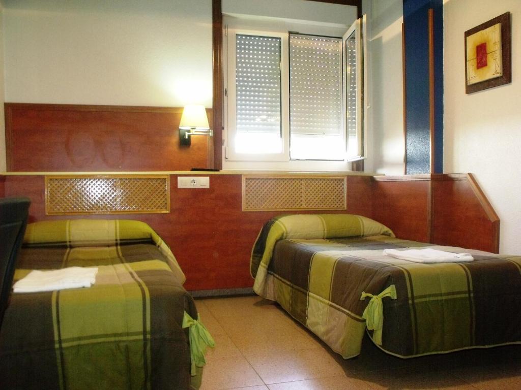 Postel nebo postele na pokoji v ubytování Hotel Ria de Bilbao