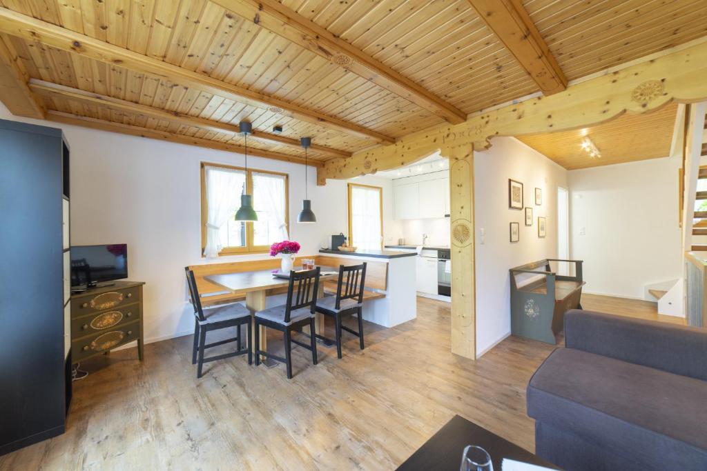 a kitchen and dining room with a table and chairs at Schönau in Wildhaus