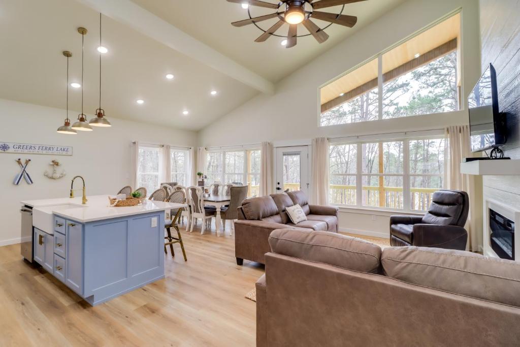 a kitchen and living room with a couch and a table at Waterfront Retreat on Greers Ferry Lake with Hot Tub in Heber Springs