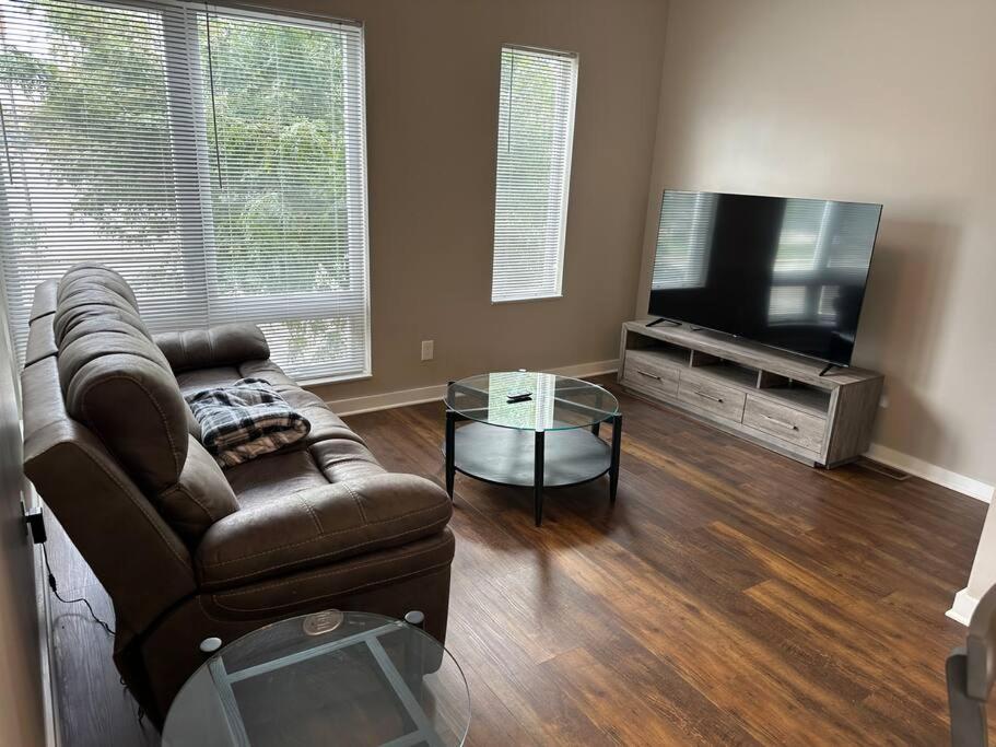 a living room with a couch and a flat screen tv at Luxury Downtown Townhome Unit 14 in Cleveland