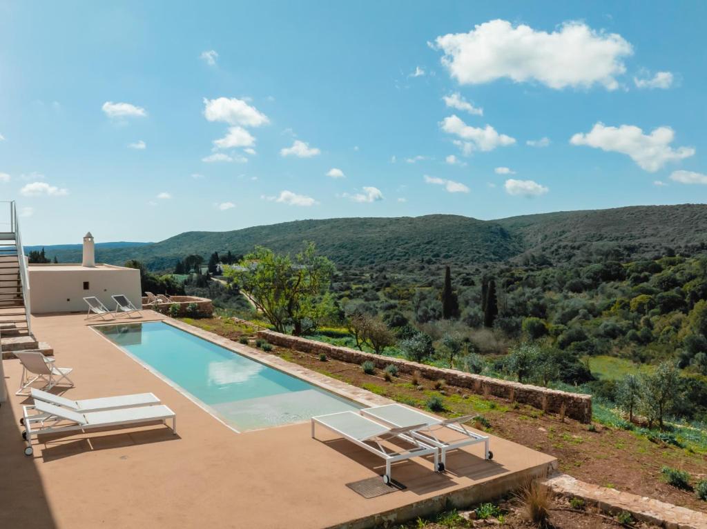 a villa with a swimming pool and a mountain view at Casa Kombonada in Kythira