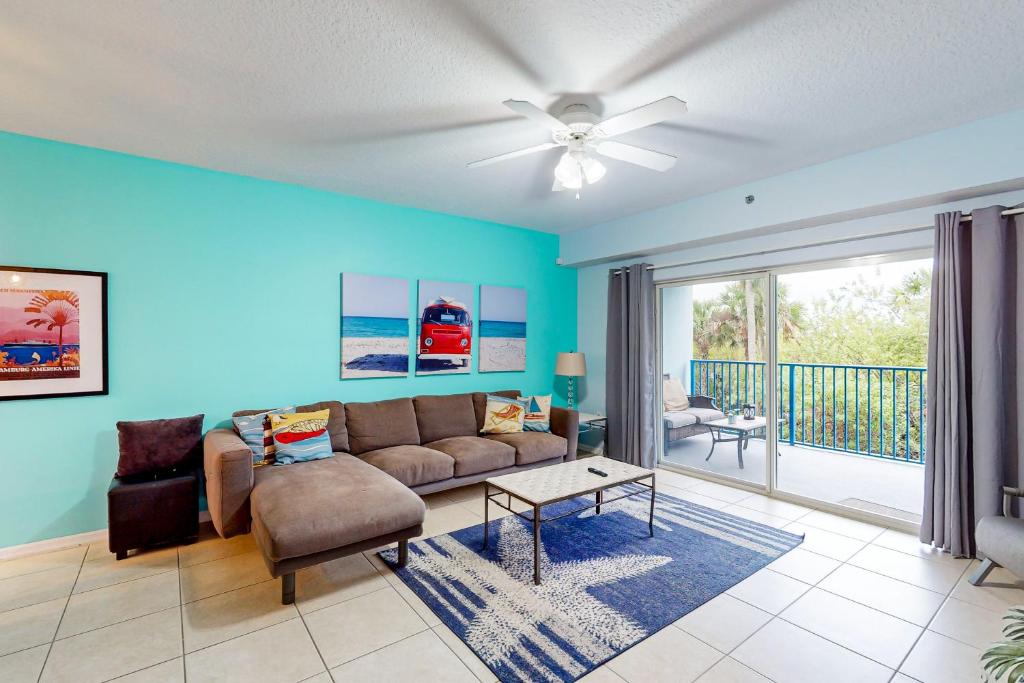 a living room with a couch and a table at Oceanwalk 10-203 in New Smyrna Beach