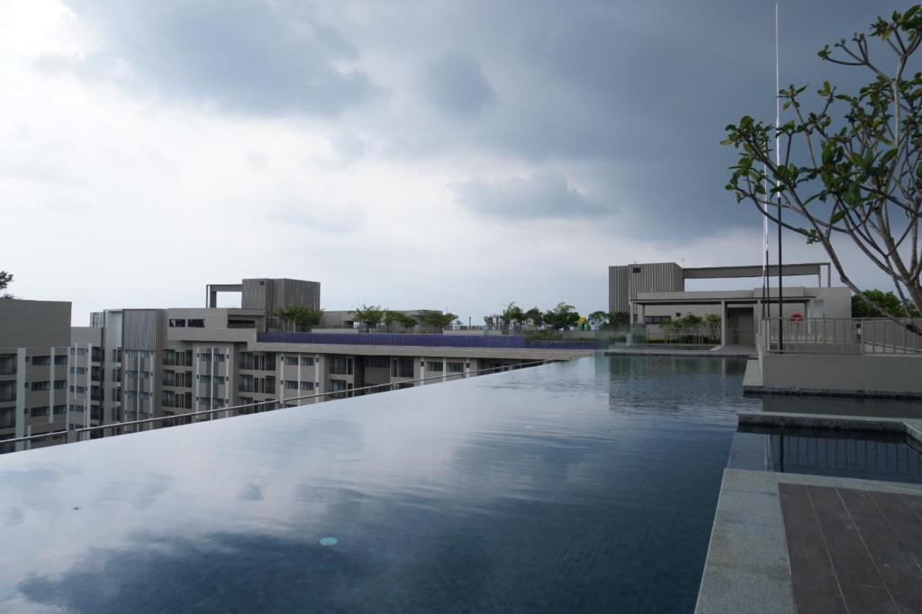 a swimming pool on the roof of a building at Camelia youth city nilai studio residence 5 pax. in Nilai