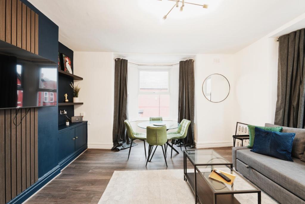 a living room with a table and a couch at Lamara Flat 2, Liverpool in Liverpool