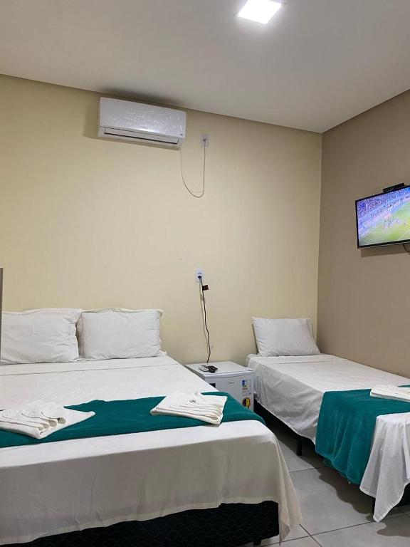 Cama ou camas em um quarto em Pousada Vista da Serra - Suzart
