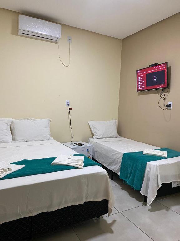 Cama ou camas em um quarto em Pousada Vista da Serra - Suzart