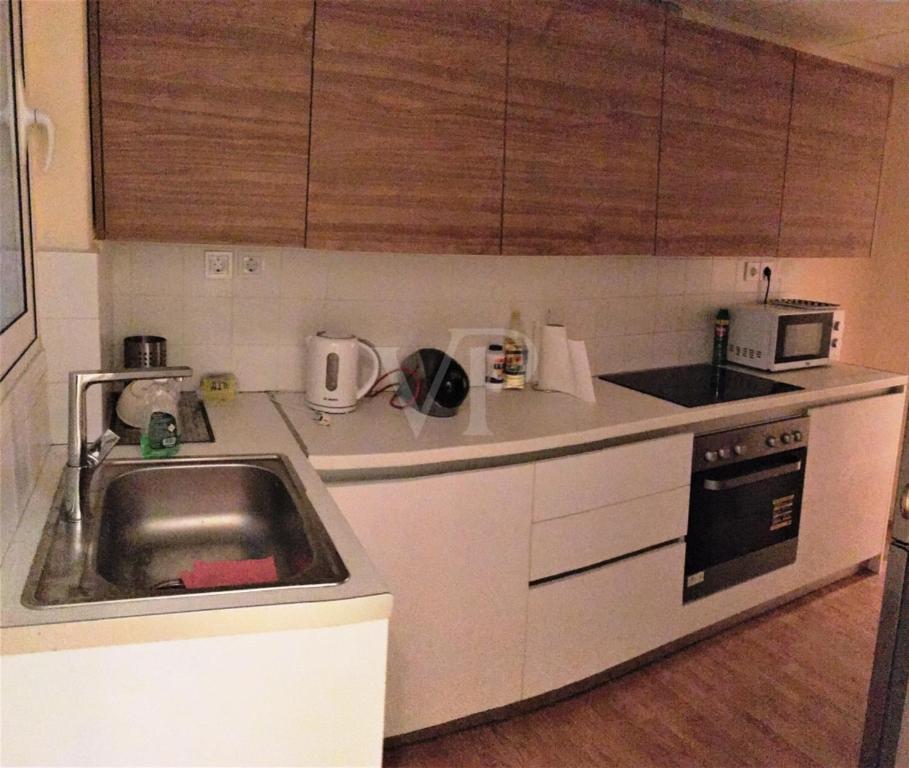a small kitchen with a sink and a microwave at Kolonaki Private Rooms in Athens