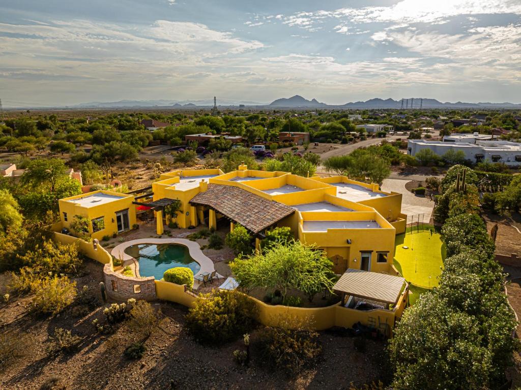 an aerial view of a yellow house with a swimming pool at Scottsdale Agave House- Located on one Acre, Resort Style Amenities and Private Casita! in Scottsdale