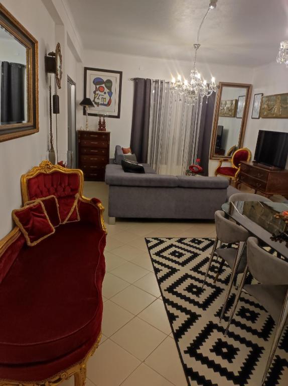 a living room with a couch and a table at Comfort Beach house in Nazaré