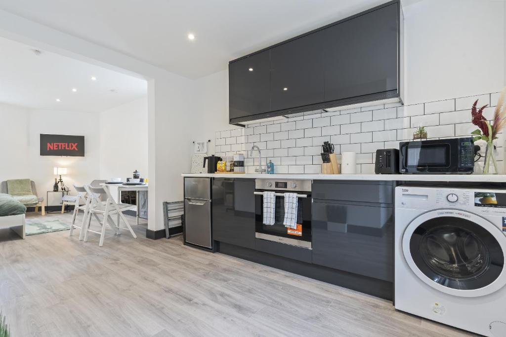 a kitchen with a washer and dryer in a room at Free Parking Ideal for solo business travellers in Ilkeston