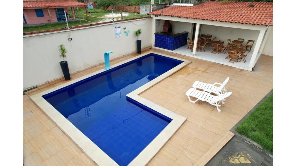 a swimming pool in front of a house at DUNAS RESIDENCE CASA 02 in Santo Amaro
