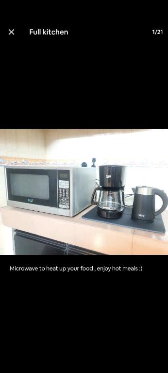 a microwave sitting on top of a counter at Any short or long term stay in Dhaka