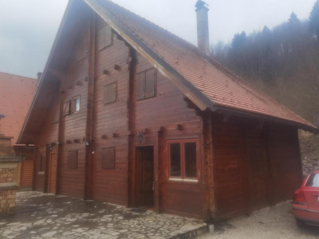 a large wooden cabin with a large door at Holiday house with a parking space Jasenak, Karlovac - 22746 in Ogulin
